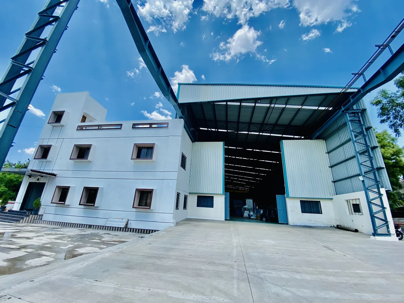 The Jitamitra works at MIDC Ahilyanagar, shed doors open onto the concrete apron