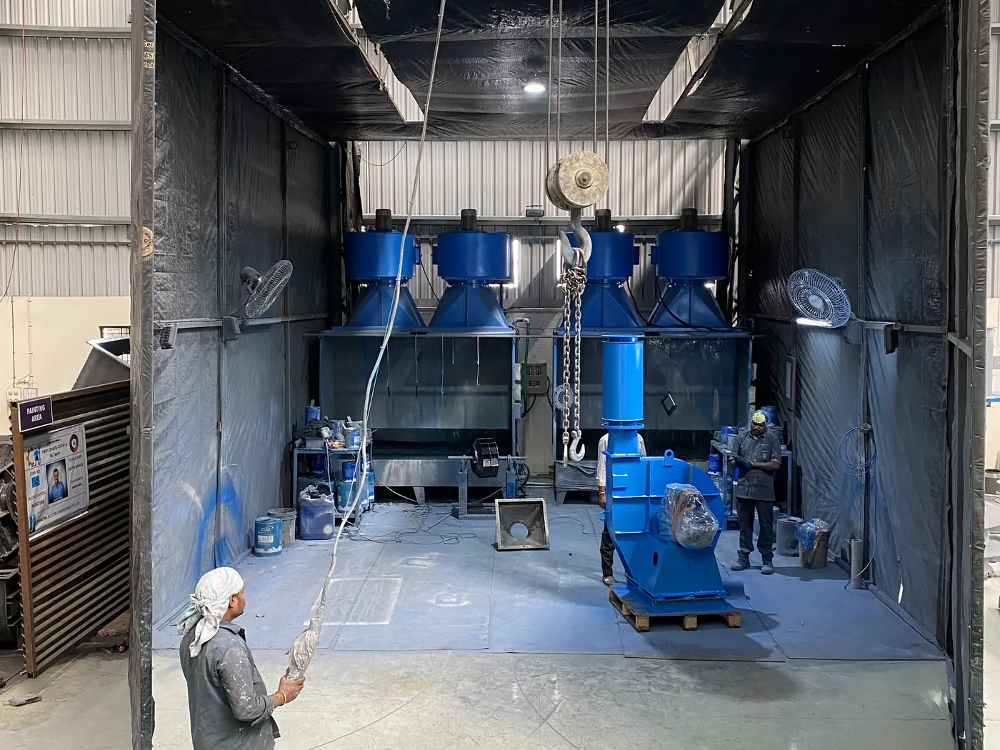 Fan casings and an impeller housing inside the curtained paint booth